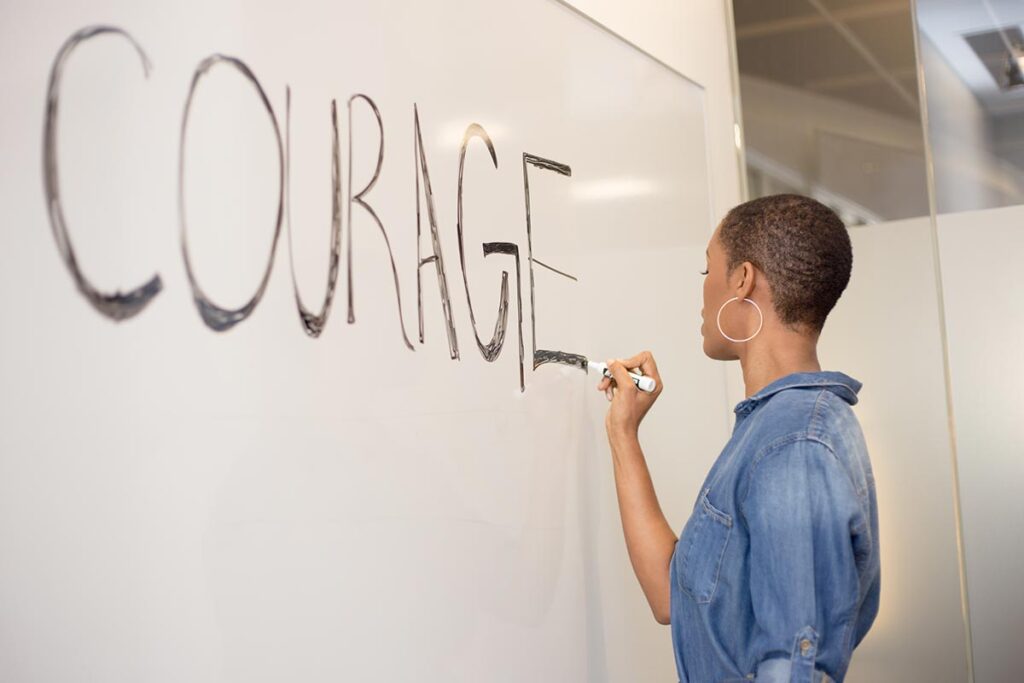 Bravery does not equal courage. Writing on chalkboard.